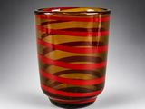 an image of a red and brown striped glass vase on a table
