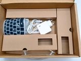 a box that has a cup in it and a charger inside of it