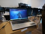 a laptop computer sitting on top of a table in a room