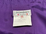 the label of a purple jacket is attached to the back of the jacket