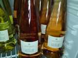 several bottles of wine are sitting on a shelf in a refrigerator