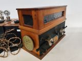 an old fashioned radio sitting on a table next to a lamp