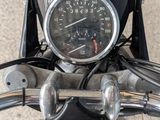 a close up of a motorcycle with a speedometer on the handlebars