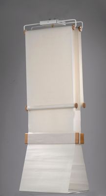 a roll up window shade hanging from a ceiling
