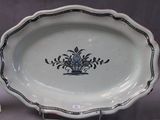 a blue and white plate with a flower design on it