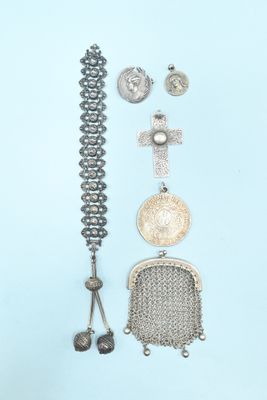 an assortment of silver jewelry on a blue background