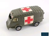 a green toy ambulance truck with a red cross on the side