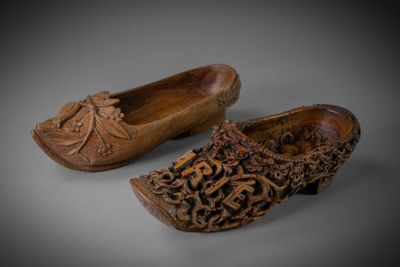 pair of carved wooden clogs with flowers on them