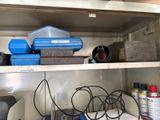 a shelf with tools and other items on it