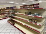 many shelves in the store that have canned food on them