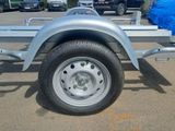 a trailer with a blue tarp on the back of it