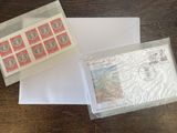 two envelopes with stamps and a stamp pad sitting on a table