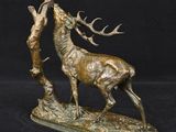 bronze sculpture of a stag with antlers on a black background