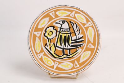 une assiette jaune sur laquelle est représenté un oiseau