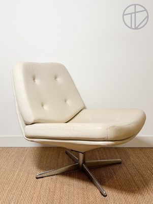 a white chair that is sitting in a room