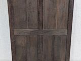 an old wooden cabinet with two doors and a drawer on top of it