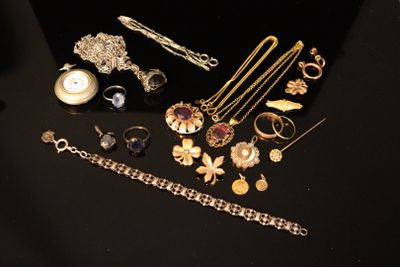 a lot of jewelry on a black table