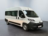 the white van is parked in a large room with a black floor