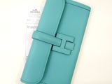 a blue leather travel wallet with a card holder on top of it