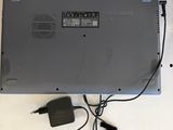 a laptop that is sitting on a table with a charger