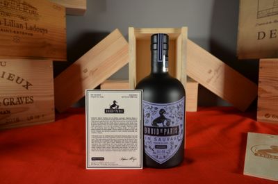 a bottle of liquor sitting on a table next to wooden crates