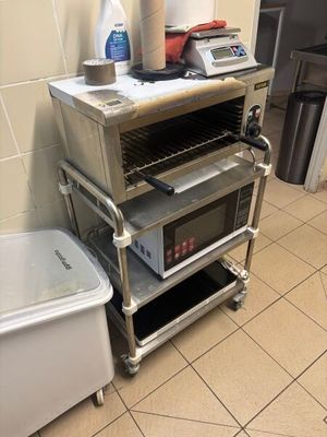 an image of a kitchen with a toaster oven and a trash can