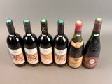 several bottles of wine are lined up on a table