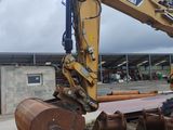 an image of a construction vehicle that is parked in the dirt