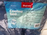 a bag of cooling bed next to a bottle of water