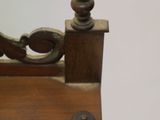 a small wooden table with a mirror on it