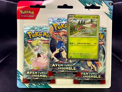two pokemon cards are in a package on a black surface