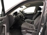 the interior of a car with the door open showing the driver ' s seat area