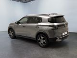 the rear view of a silver suv parked in a room