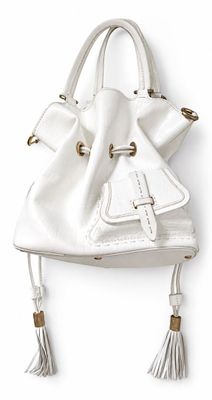 the white purse is hanging on the wall on the wall