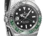 a close up of a wrist watch with a green bezel