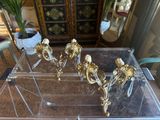 a glass table that has a bunch of gold decorations on it