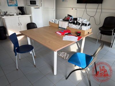 tables and chairs in a room with a flat screen tv