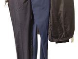 two men ' s pants hanging on a clothes rack on a white background