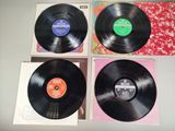 three black vinyl records sitting on top of a table next to each other