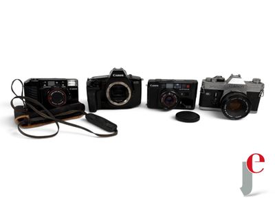 four cameras are lined up on a white surface with a camera strap