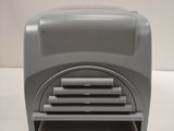 a gray toaster sitting on a table with a white background
