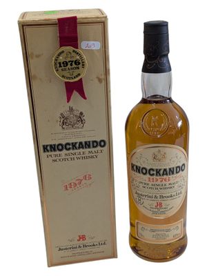 a close up of a bottle of knockando whisky next to a box