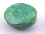 a close up of a green stone on a white surface