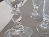 three empty wine glasses sitting on a table next to each other