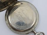 a silver pocket watch with a chain attached to it