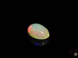an image of a white fire opal in the dark