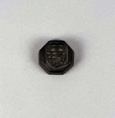 a close up of a small metal object on a white surface