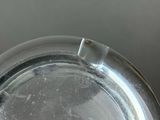 a close up of a glass plate with a bug on it