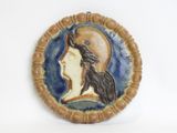 a picture of a ceramic plaque of a woman ' s face