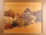 une photo d'un tableau représentant une maison accrochée à un mur